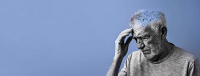 Elderly senior old thinking man suffering from dementia with puzzles on head